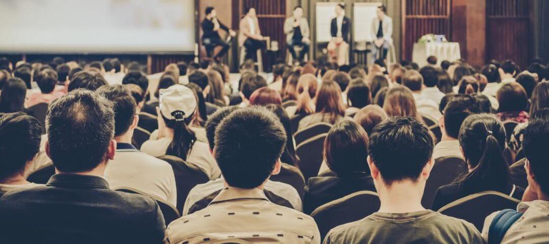 public speaker addressing audience in misuse of pronouns